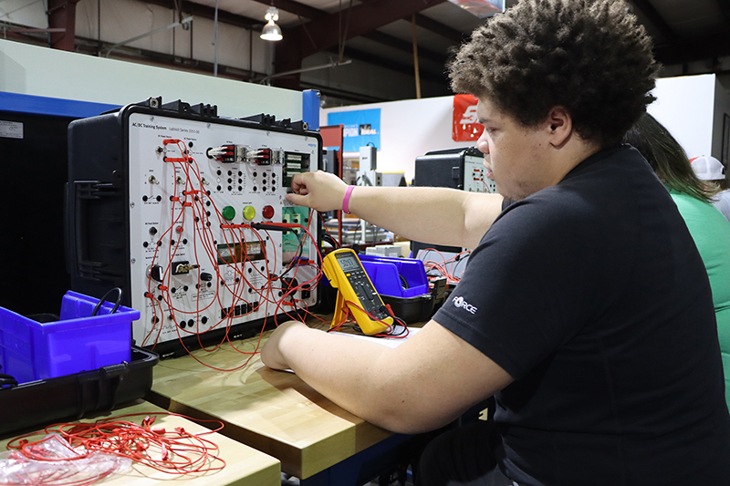 Student in classroom on equipment.